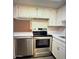 Kitchen featuring stainless steel oven and dishwasher, white cabinets and countertop, and wood floors at 12221 W Bell Rd # 119, Surprise, AZ 85378