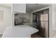 Bright kitchen features white cabinetry, modern appliances, breakfast bar, and in-unit washer and dryer at 12221 W Bell Rd # 119, Surprise, AZ 85378