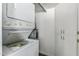 Convenient laundry area with stacked washer/dryer and built-in storage cabinets at 12221 W Bell Rd # 119, Surprise, AZ 85378