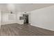A spacious living room with new wood floors, and a kitchen in the background at 12221 W Bell Rd # 119, Surprise, AZ 85378