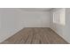 Bright living room with new wood floors and neutral-colored walls and a white door at 12221 W Bell Rd # 119, Surprise, AZ 85378