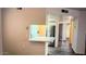 Living Room with hardwood floors and view into the kitchen with stainless steel refrigerator at 12221 W Bell Rd # 119, Surprise, AZ 85378