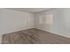 Bright living room with new wood floors and neutral-colored walls and a white door at 12221 W Bell Rd # 119, Surprise, AZ 85378