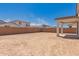 Large backyard featuring a covered patio and privacy fencing at 12361 W Marguerite Ave, Avondale, AZ 85323