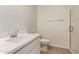 Bright bathroom featuring a modern vanity, toilet, and walk-in shower with glass door at 12361 W Marguerite Ave, Avondale, AZ 85323