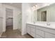 Bright bathroom featuring double vanity, large mirror and glass shower at 12361 W Marguerite Ave, Avondale, AZ 85323