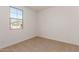 Well-lit bedroom showcasing a view of the neighborhood through the window at 12361 W Marguerite Ave, Avondale, AZ 85323