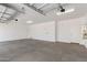 Spacious two car garage with concrete flooring and overhead lighting at 12361 W Marguerite Ave, Avondale, AZ 85323