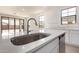 Close-up of modern kitchen featuring a stainless steel sink, quartz countertops, and stainless steel appliances at 12361 W Marguerite Ave, Avondale, AZ 85323