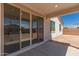 Covered patio with sliding glass doors leading to the interior of the home at 12361 W Marguerite Ave, Avondale, AZ 85323