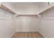 Bright walk-in closet with carpet flooring and multiple rows of shelving at 12361 W Marguerite Ave, Avondale, AZ 85323