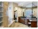 A primary bathroom featuring a soaking tub, vanity and access to a walk-in closet at 14725 N Mariposa Ct, Fountain Hills, AZ 85268
