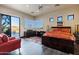 Well-lit bedroom with a large sliding glass door, a private balcony, dark hardwood floors, and desert views at 14725 N Mariposa Ct, Fountain Hills, AZ 85268