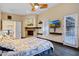 A primary bedroom displaying dark wood floors, fireplace, tv and access to an outdoor area at 14725 N Mariposa Ct, Fountain Hills, AZ 85268