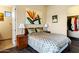 This well-lit bedroom features a queen-size bed, neutral walls, two side tables, and art at 14725 N Mariposa Ct, Fountain Hills, AZ 85268