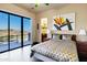 Bright bedroom with a sliding glass door, a private balcony, a queen-size bed, and desert views at 14725 N Mariposa Ct, Fountain Hills, AZ 85268