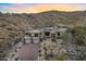 Elegant desert home featuring an elongated drive, three car garage, and lush, mature landscaping at 14725 N Mariposa Ct, Fountain Hills, AZ 85268
