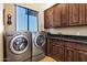 Well-equipped laundry room with a sink, countertop, and custom wood cabinets at 14725 N Mariposa Ct, Fountain Hills, AZ 85268