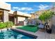 Inviting pool area with outdoor kitchen, lounge chairs, and lush landscaping at 14725 N Mariposa Ct, Fountain Hills, AZ 85268