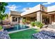 Lush backyard featuring a sparkling pool, rock features, and covered patio at 14725 N Mariposa Ct, Fountain Hills, AZ 85268