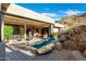 Outdoor view of a sparkling pool surrounded by rock features and a cozy patio area at 14725 N Mariposa Ct, Fountain Hills, AZ 85268