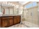 Bathroom featuring a glass-enclosed shower and a dark wood vanity with ample storage at 1474 E Elysian Pass, Queen Creek, AZ 85140