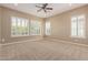 Large bedroom with carpeted flooring and plantation shuttered windows provides ample natural light and a cozy feel at 1474 E Elysian Pass, Queen Creek, AZ 85140