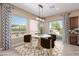 Cozy dining room featuring modern decor, stylish chairs, and large windows at 1474 E Elysian Pass, Queen Creek, AZ 85140