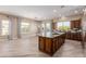 Open-concept kitchen featuring a large island, tile floors, and plenty of natural light at 1474 E Elysian Pass, Queen Creek, AZ 85140