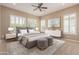 Serene main bedroom with plush carpet, shutters, and a stylish ensuite bathroom at 1474 E Elysian Pass, Queen Creek, AZ 85140