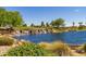 Scenic water feature in a lush green golf community featuring a gentle waterfall flowing over stone at 1474 E Elysian Pass, Queen Creek, AZ 85140