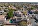 Aerial view of a neighborhood showcasing a home with solar panels and a private backyard pool at 15260 W Alexandria Way, Surprise, AZ 85379