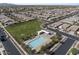 Aerial view of neighborhood with community pool, park, and neatly arranged homes at 15260 W Alexandria Way, Surprise, AZ 85379