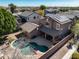 Aerial view of a private backyard featuring a kidney-shaped pool, patio, and well-maintained landscaping at 15260 W Alexandria Way, Surprise, AZ 85379