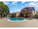 Backyard view featuring a refreshing pool, covered patio, and lush landscaping at 15260 W Alexandria Way, Surprise, AZ 85379
