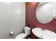 Cozy powder room featuring a pedestal sink and decorative mirror at 15260 W Alexandria Way, Surprise, AZ 85379