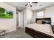 Bedroom with carpet floor, large window, and a door to the bathroom at 15260 W Alexandria Way, Surprise, AZ 85379
