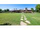 Beautifully landscaped common area featuring stone pathway, fireplace, and grill at 15260 W Alexandria Way, Surprise, AZ 85379