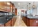 Spacious kitchen with granite countertops, stainless appliances, and dark wood cabinets at 15260 W Alexandria Way, Surprise, AZ 85379