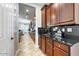 Gourmet kitchen with granite countertops, dark cabinetry and decorative backsplash at 15260 W Alexandria Way, Surprise, AZ 85379