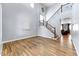 Spacious living room with hardwood floors and grand staircase at 15260 W Alexandria Way, Surprise, AZ 85379