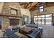 Relaxing lounge with stone fireplace, comfortable seating and access to outdoor amenities at 15260 W Alexandria Way, Surprise, AZ 85379
