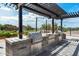 Covered outdoor kitchen equipped with stainless steel grills and prep area for community cookouts at 15260 W Alexandria Way, Surprise, AZ 85379