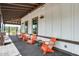 Inviting outdoor seating area with modern orange chairs and stylish decor at 15260 W Alexandria Way, Surprise, AZ 85379