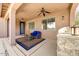 Outdoor seating and a grill area on a covered patio with ceiling fan at 15260 W Alexandria Way, Surprise, AZ 85379