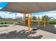 Community playground shaded structure, with modern equipment for children at 15260 W Alexandria Way, Surprise, AZ 85379