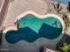 Aerial view of a sparkling pool with baja step and water features, surrounded by a well-maintained patio at 15260 W Alexandria Way, Surprise, AZ 85379
