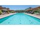 Large pool with beautiful tile and clear water, surrounded by mature trees at 15260 W Alexandria Way, Surprise, AZ 85379
