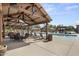 Stunning pool area with shaded seating, lush landscaping, and resort-style ambiance at 15260 W Alexandria Way, Surprise, AZ 85379