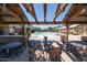 Charming poolside patio with ample seating and shaded pergolas for relaxation at 15260 W Alexandria Way, Surprise, AZ 85379